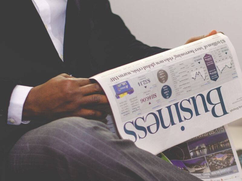 Man holding a business newspaper