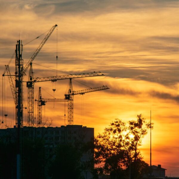 Sunset with cranes and building